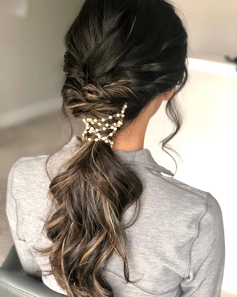 Textured Low Ponytail with Soft Volume and Bangs