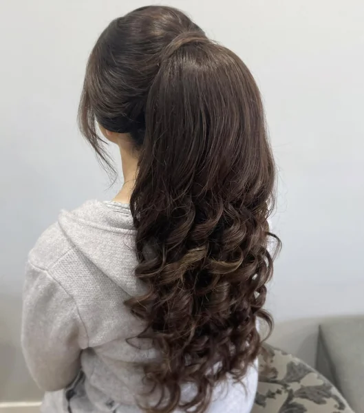 Voluminous High Ponytail with Rich Chocolate Curls