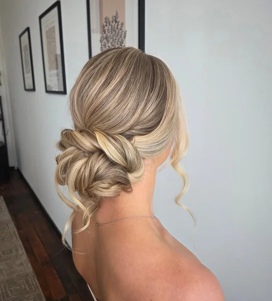 Voluminous Intertwined Blonde Low Bun with Tendrils