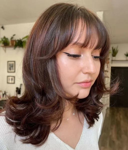 Voluminous Retro Blowout with Full Fringe Bangs