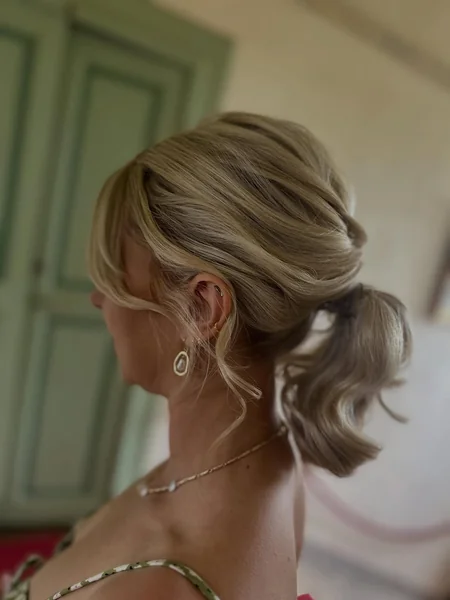 Voluminous Twisted Updo with Wavy Low Ponytail
