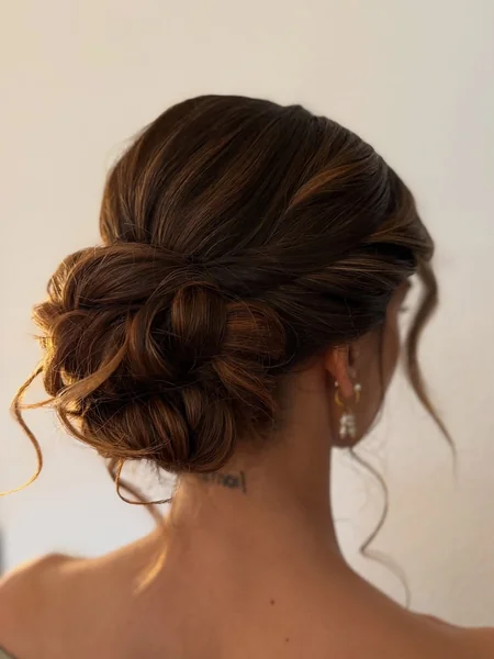 Voluminous Woven Low Bun with Rich Brunette Highlights