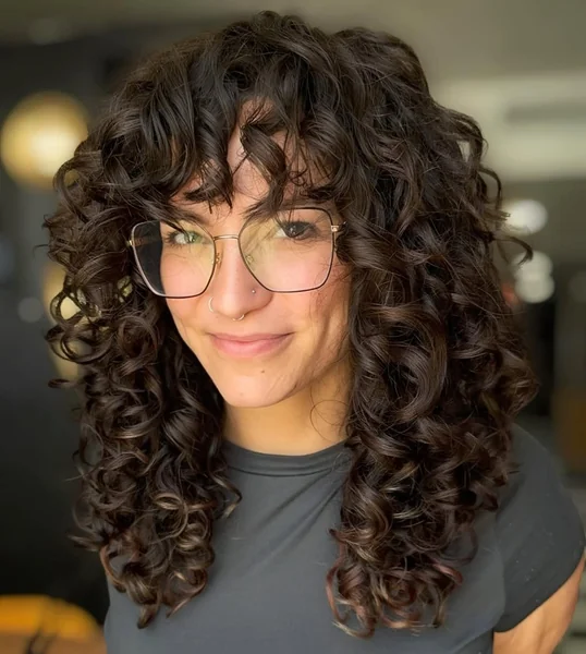 Voluminous Chocolate Ringlets with Face-Framing Curly Bangs