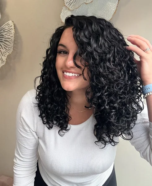 Voluminous Raven Ringlets with Sun-Kissed Shine