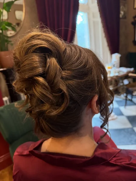 Voluminous Toffee-Toned Updo with Artistic Layered Loops